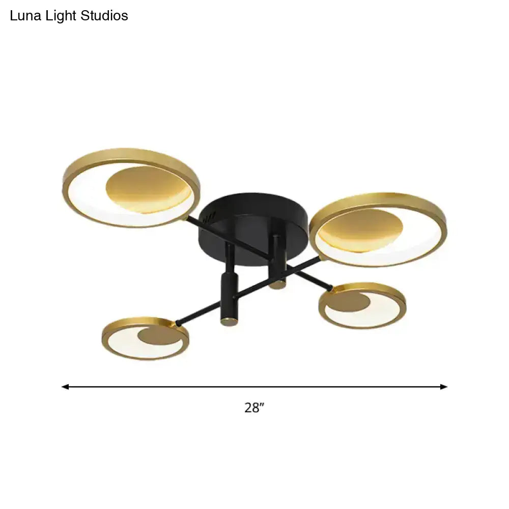 Modern gold molecule ceiling mount chandelier with four gold-toned circular shades and illuminated inner circles