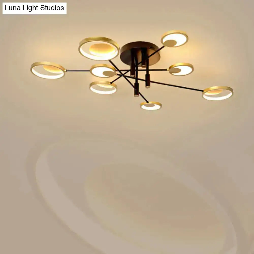 Modern gold molecule ceiling mount chandelier with eight gold-rimmed bulbs in starburst pattern on black arms for living room