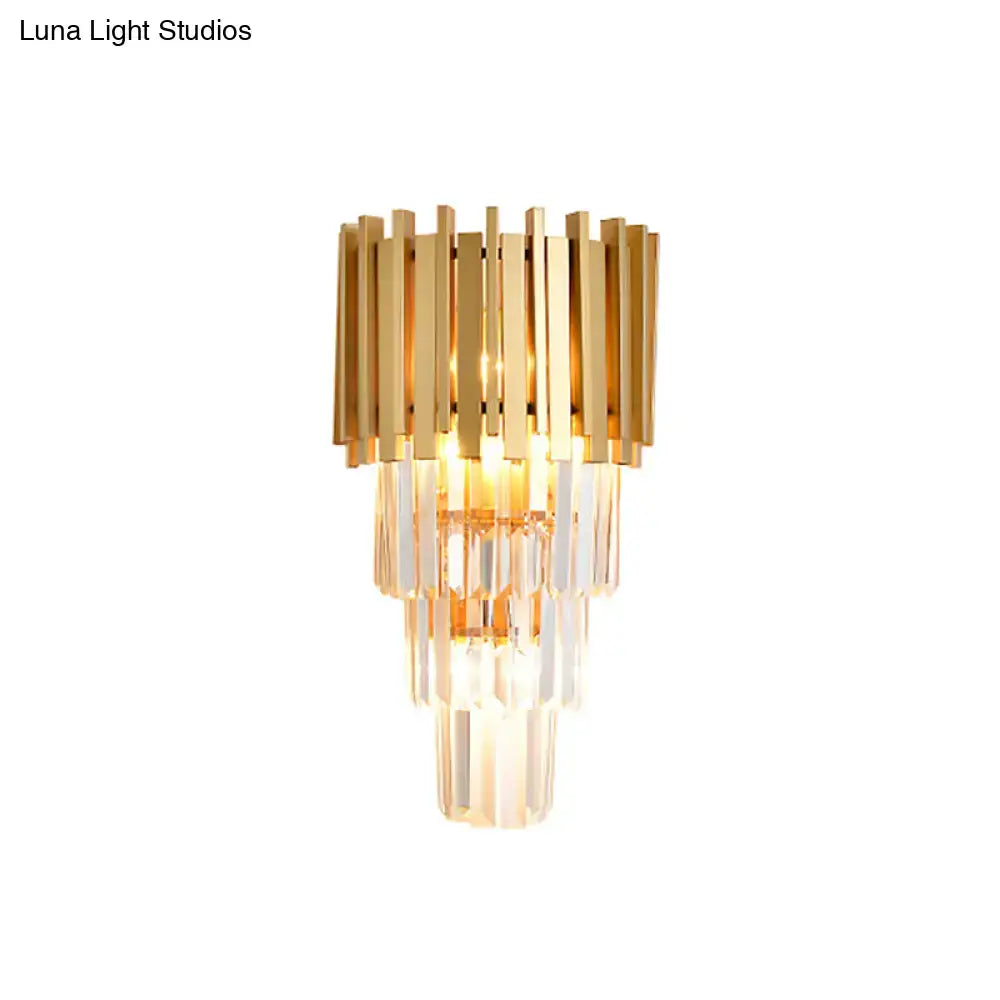 Modern gold wall light with tiered vertical crystal prisms designed as a stylish dining room wall lamp