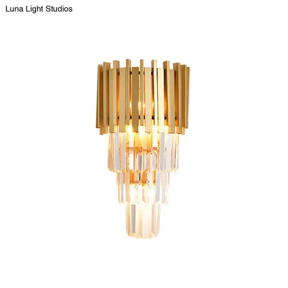 Modern gold wall light with tiered vertical crystal prisms designed as a stylish dining room wall lamp