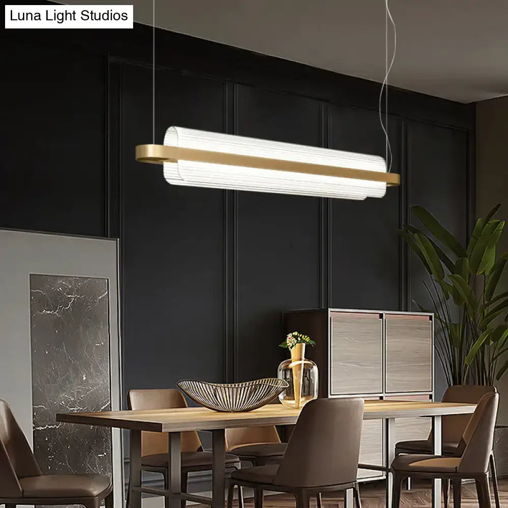 Modern rectangular nordic linear island lamp with white ribbed acrylic diffuser and gold metal accents for dining room