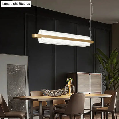 Modern rectangular nordic linear island lamp with white ribbed acrylic diffuser and gold metal accents for dining room