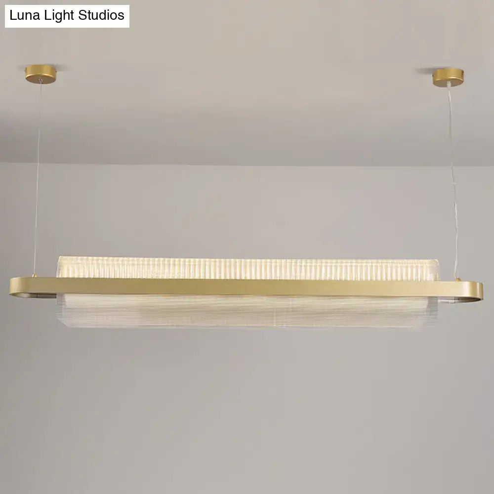 Modern gold-toned nordic linear island lamp with textured acrylic diffuser and sleek metallic frame for dining room lighting