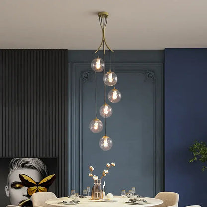 A modern brass decorbites gold nordic pendant light with five glass bulbs cascading for dining room chandelier decor