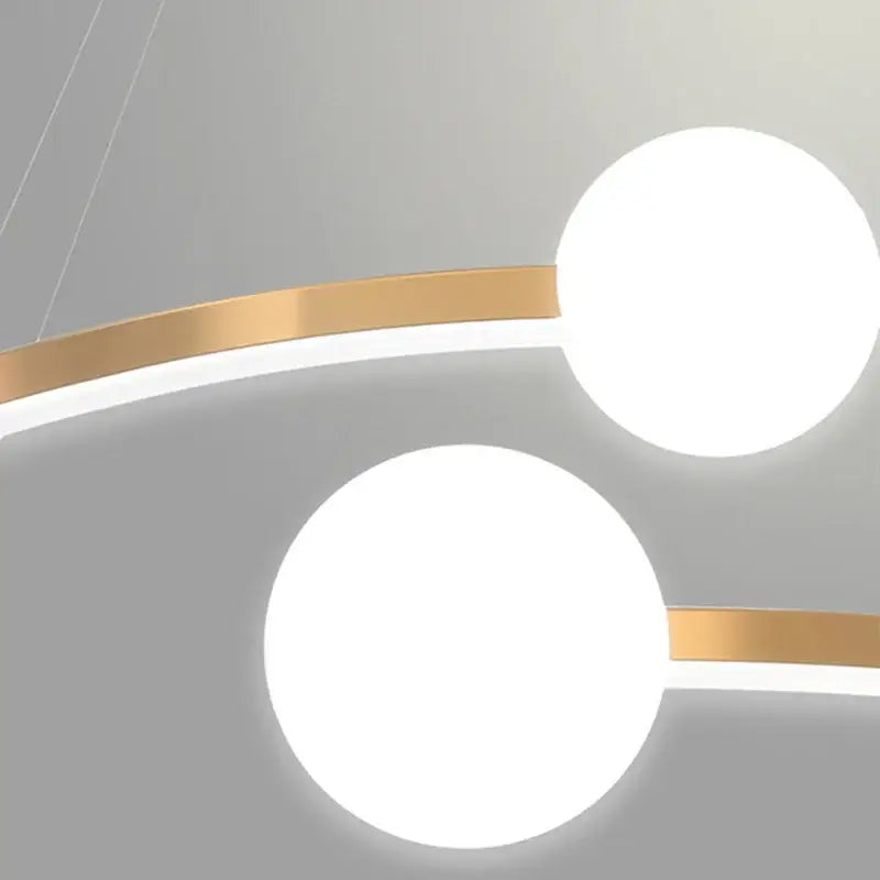 Modern gold nordic ring led chandelier with two glowing white spherical bulbs and sleek gold-toned metallic bands for dining room decorbites gold nordic