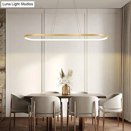 Modern gold oblong led pendant light fixture with chain cord length and warm white color above dining table
