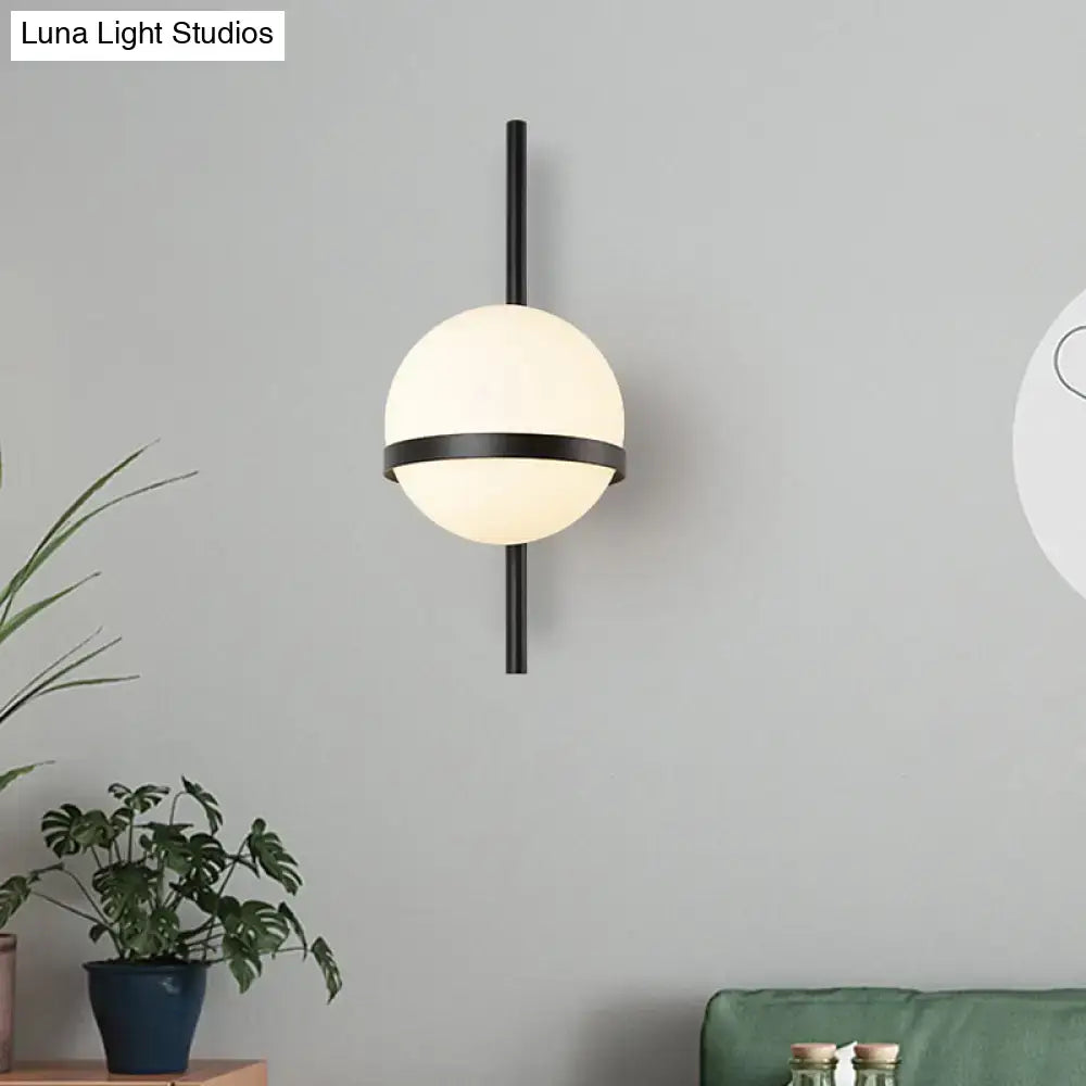 Modern black metal wall sconce with frosted white opal glass orb suitable for living room lighting