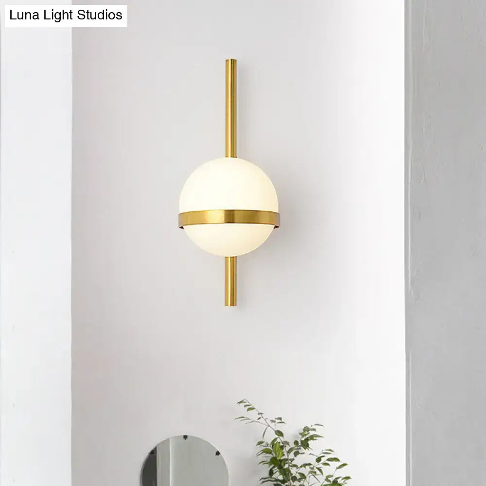Modern gold opal glass orb wall sconce with a frosted opal glass orb and minimalist metallic gold accents for living room lighting