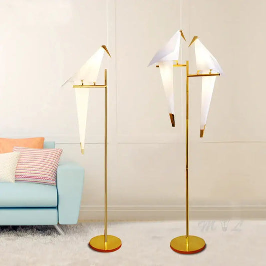 Modern gold origami bird floor lamp with white paper shades for minimalist home decor and living room reading light