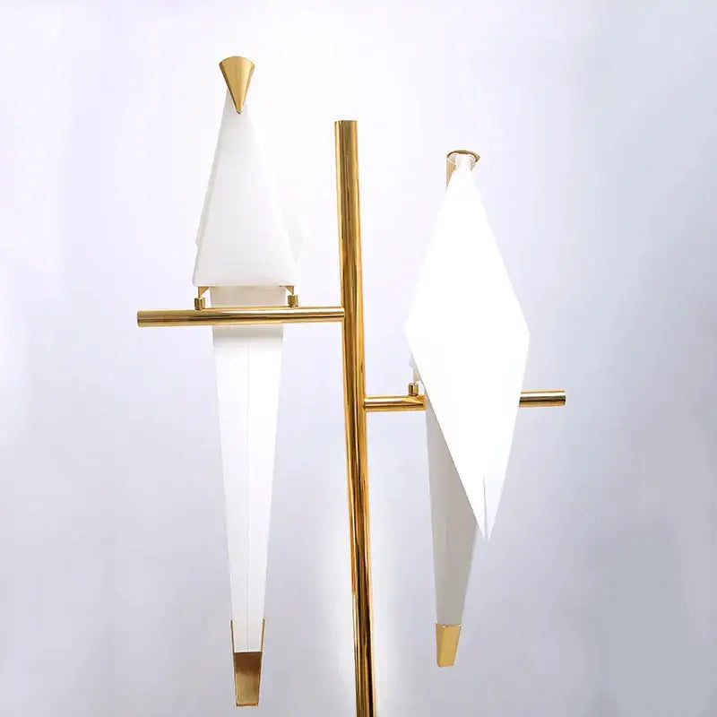 Modern gold origami bird floor lamp with gold metal frame and two white geometric lampshades for home decor