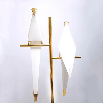 Modern gold origami bird floor lamp with gold metal frame and two white geometric lampshades for home decor