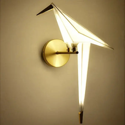 Modern gold origami bird floor lamp with illuminated white paper-like wings and a gold metal base for home decor