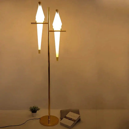 Modern gold origami bird floor lamp with two illuminated tapered glass shades for elegant home decor lighting