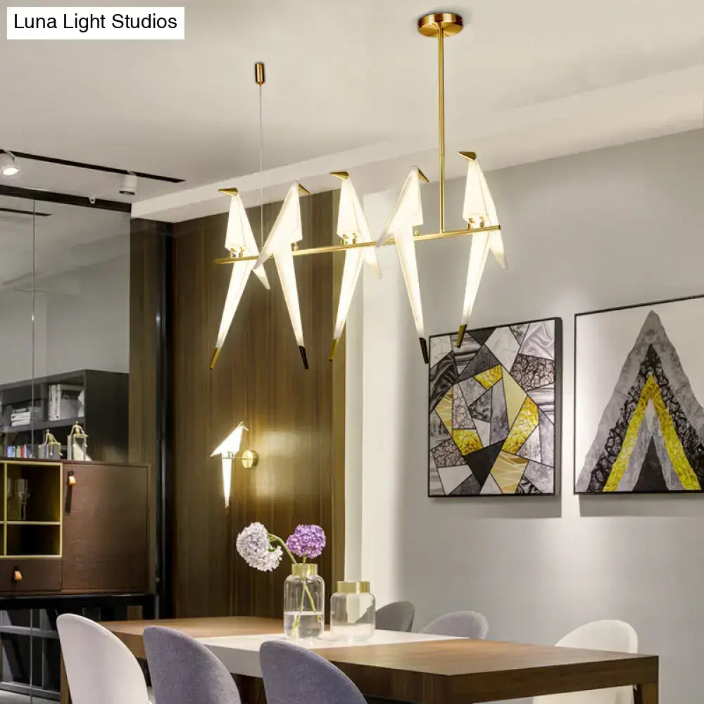 Modern gold origami bird pendant light with angular white translucent lampshades for dining room decor