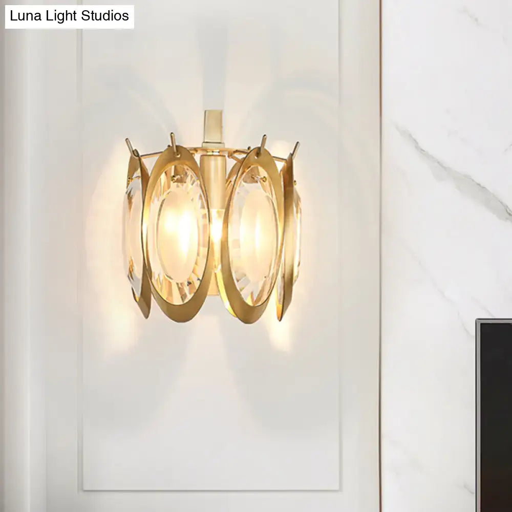 Modern gold oval crystal wall light features a gold-toned wall light with circular glass panels around a central stem