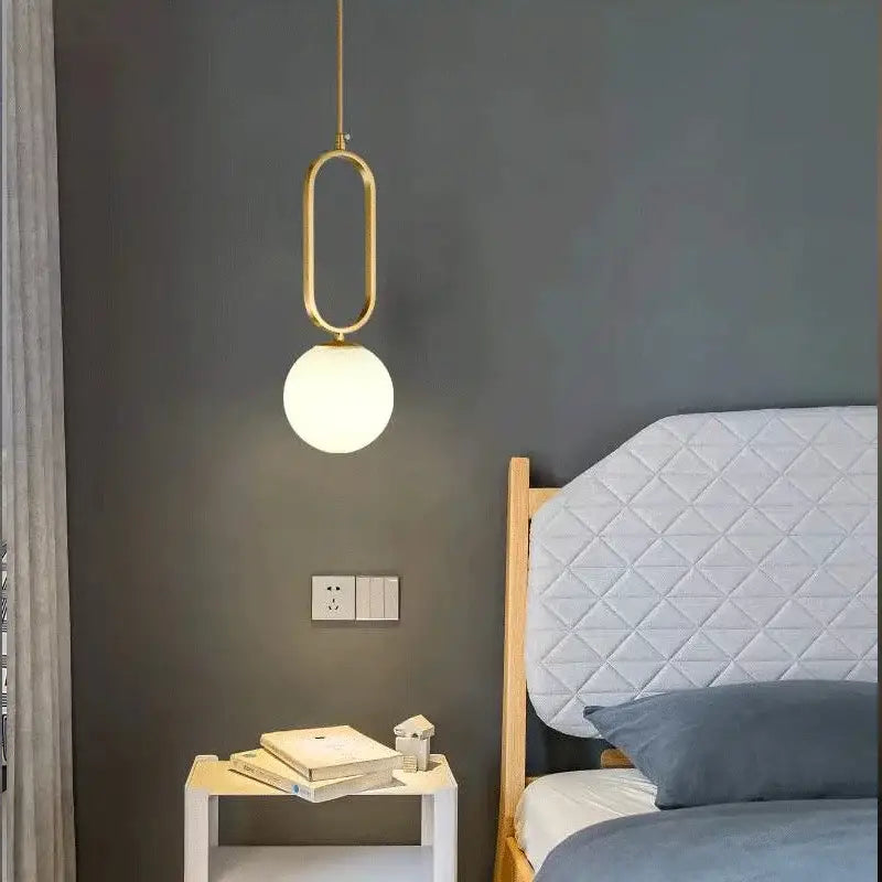 Modern gold pendant light with sleek oval frame and frosted glass ball perfect for dining room decorbites pendant lights