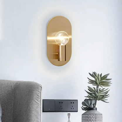 Modern gold oval sconce bedroom light with bare bulb metal shade and exposed filament bulb in sleek design