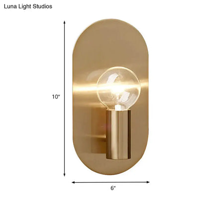 Modern gold oval sconce bedroom light featuring a sleek brushed brass bare bulb metal shade with clear glass bulb