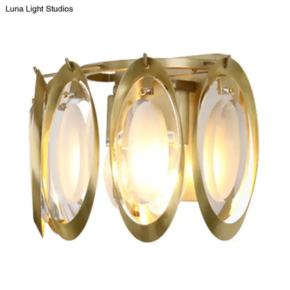 Modern gold oval sconce light with three glass panels featuring a sleek design for living room wall fixture