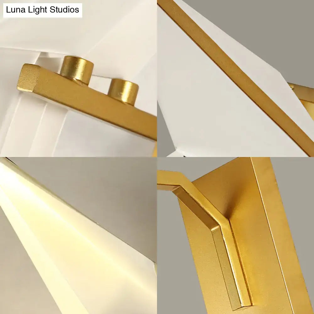 Modern gold dining room sconce wall lamp with geometric polished metal frame and sleek birdie plastic shade diffuser