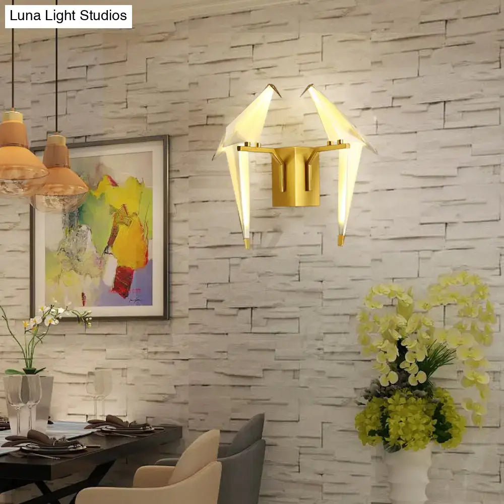 Gold-toned modern dining room sconce wall lamp with two origami-style birdie plastic shades resembling paper cranes