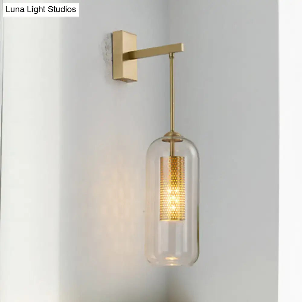 Modern gold perforated sconce with clear glass cylinder and intricate gold inner tube for bedroom wall light