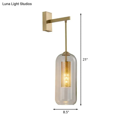 Modern gold perforated wall sconce with clear glass cylinder and illuminated brass mesh panel for bedroom lighting