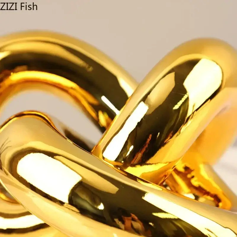 Shiny gold-plated knot ornaments featuring a metallic chain with interlocking rounded links for modern living room decorbites decor