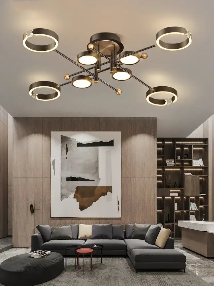 Modern gold plated luxury chandelier with multiple circular rings and spherical accents in brushed brass finish by decorbites