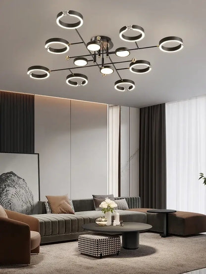 Modern black circular plated luxury chandelier with glowing ring lights and central metallic fixture for living room decorbites gold plated