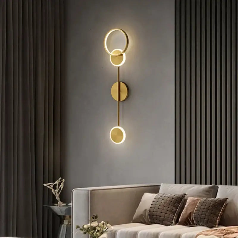 Modern gold plated three disc led wall lamp featuring a circular gold toned sconce for elegant bedroom decorbites wall lamp
