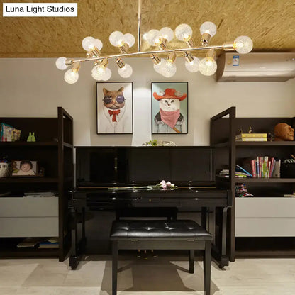 Black grand piano with glossy finish and matching bench beneath a decorbites gold prismatic glass ceiling light with bulb base