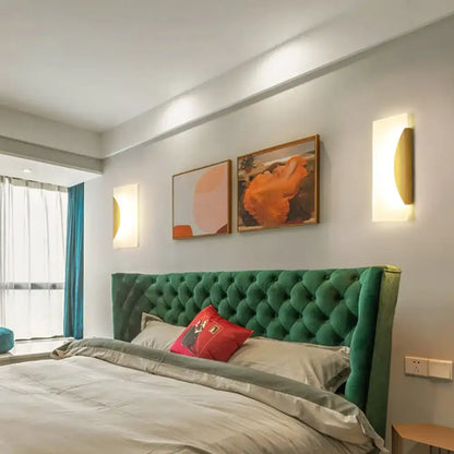 Emerald green tufted velvet headboard with plush button-tufted design paired with modern gold rectangular acrylic wall sconce bulb included