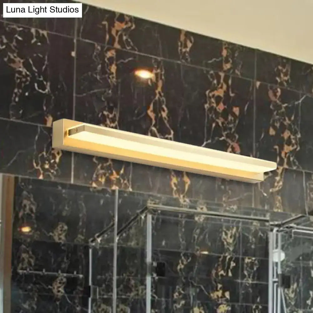 Modern gold rectangular led wall sconce with acrylic shade and minimalist design mounted above glass shower enclosure