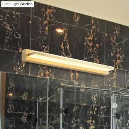 Modern gold rectangular led wall sconce with acrylic shade and minimalist design mounted above glass shower enclosure
