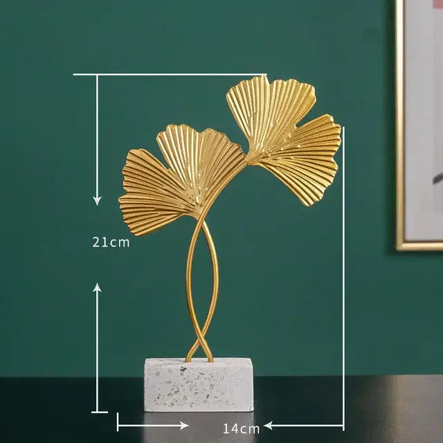 Modern gold resin sculpture featuring a golden metallic ginkgo leaf on a white marble base by decorbites gold resin