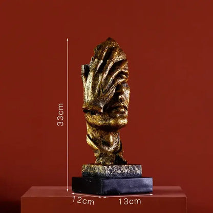 Modern gold resin sculpture living room abstract figurine featuring a golden metallic face with hands covering eyes on a dark base decorbites gold resin