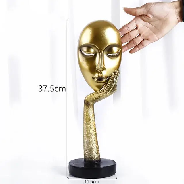 Modern gold resin sculpture living room abstract figurine featuring a golden sculpted face with hand on cheek on black base decorbites gold resin