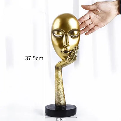 Modern gold resin sculpture living room abstract figurine featuring a golden sculpted face with hand on cheek on black base decorbites gold resin