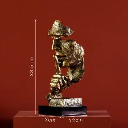 Modern gold resin sculpture featuring a golden metallic face with hand to lips on a black base decorbites gold resin decorbites gold