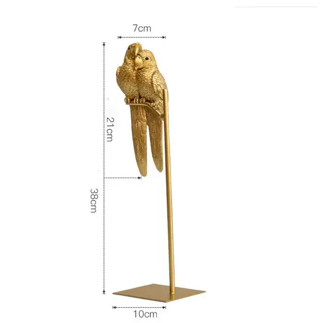 Modern gold resin sculpture featuring a gold resin sculpture parrot with detailed feathers on a square base decorbites gold resin