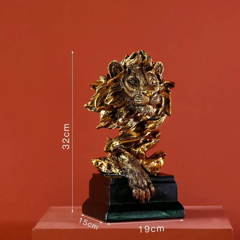 Modern gold resin sculpture featuring a detailed golden lion head with mane and paw on a black base for decorbites gold resin decor