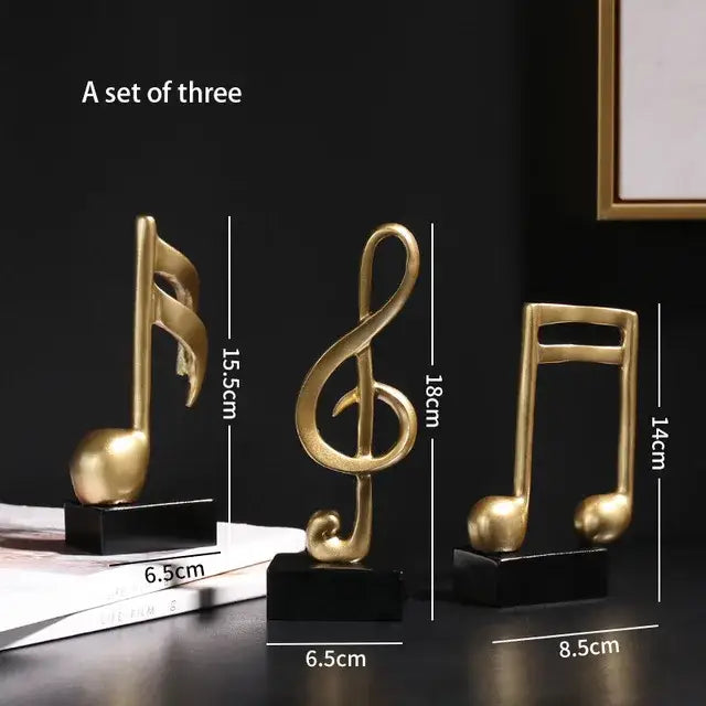 Set of three modern gold resin sculpture musical notes on black bases for living room decor by decorbites gold resin