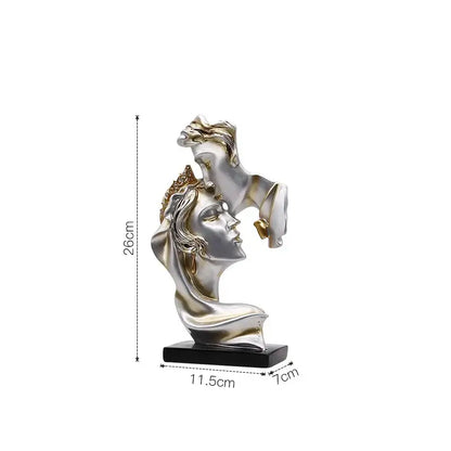 Modern gold resin sculpture featuring silver and gold-toned intertwined female busts on black base decorbites gold resin decorbites gold