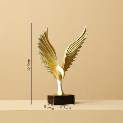 A sleek two-toned golden and silver decorbites gold resin eagle sculpture on black base for modern living room decor