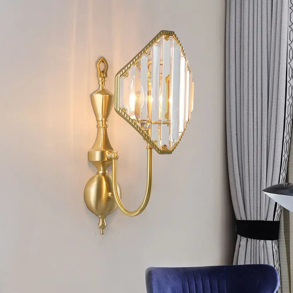 Modern gold wall lamp with hexagonal crystal prism shade and ornate metalwork for elegant bedroom lighting
