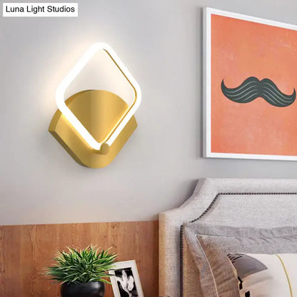 Modern gold rhombus led wall sconce with a warm white glowing ring and direct wired electric power source