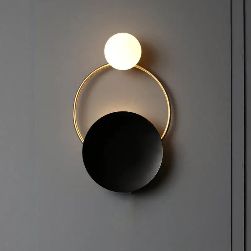 Modern gold ring ball g4 round wall lamp with decorbites glass ball, black matte disc, and glowing spherical bulb