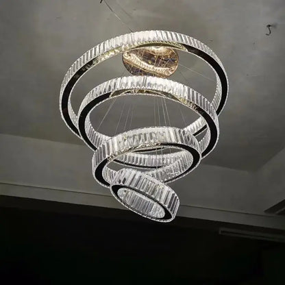 A modern gold ring decorbites crystal led chandelier with faceted crystal rings and central golden fixture for living room light