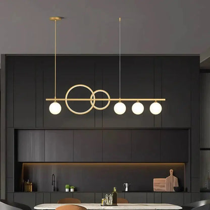 Modern gold-toned pendant light with intersecting circular rings and frosted glass bulbs from decorbites elegant chandelier dining collection